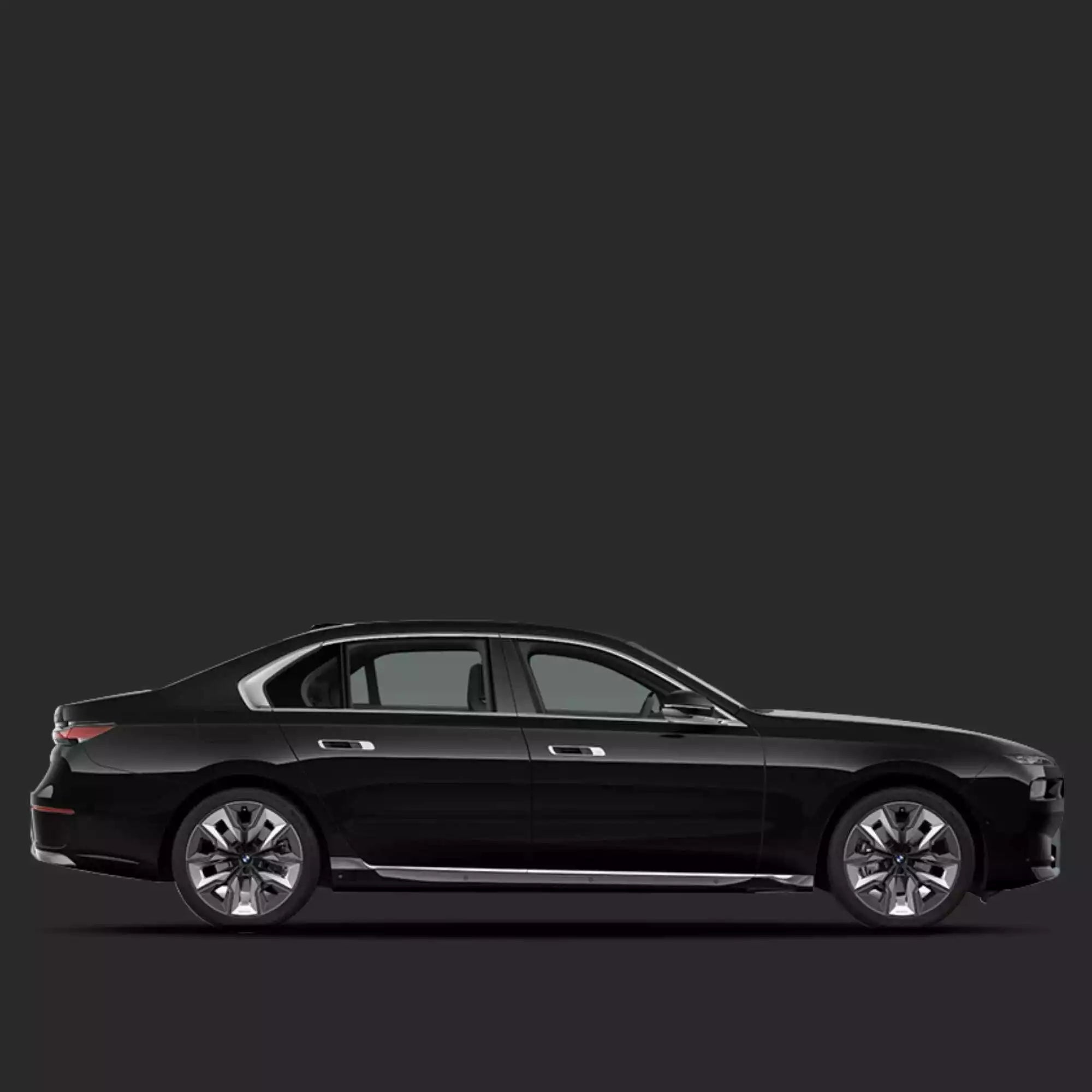 Side view of a black sedan on a dark background