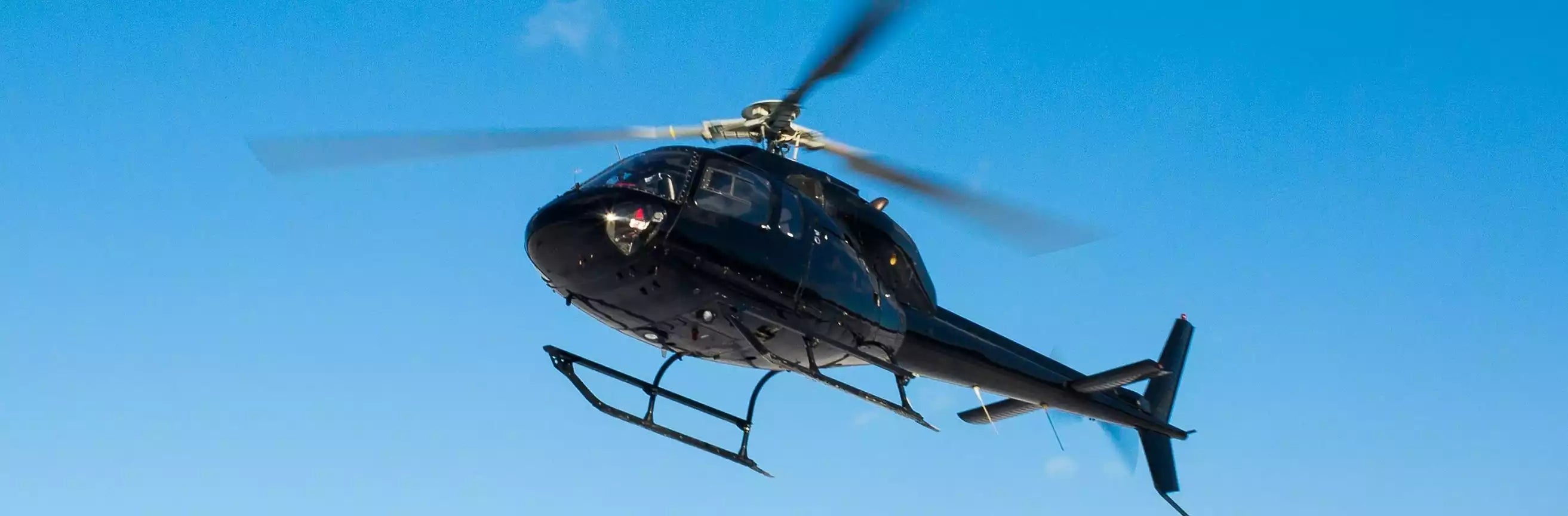 Helicopter flying against a clear blue sky