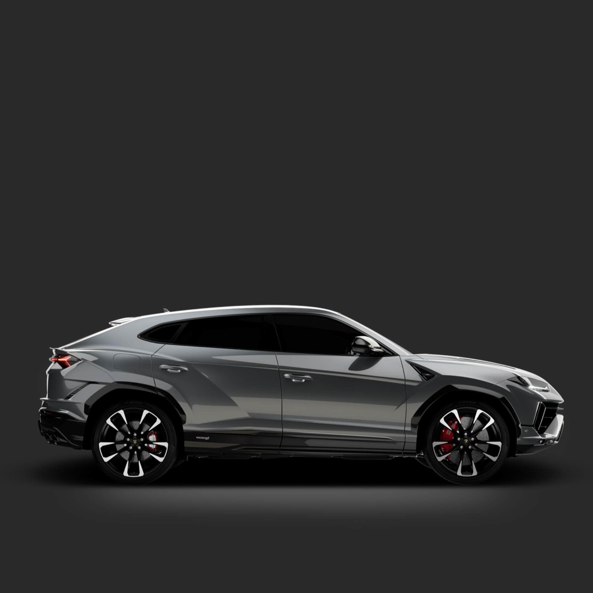 Side view of a silver SUV on a dark background