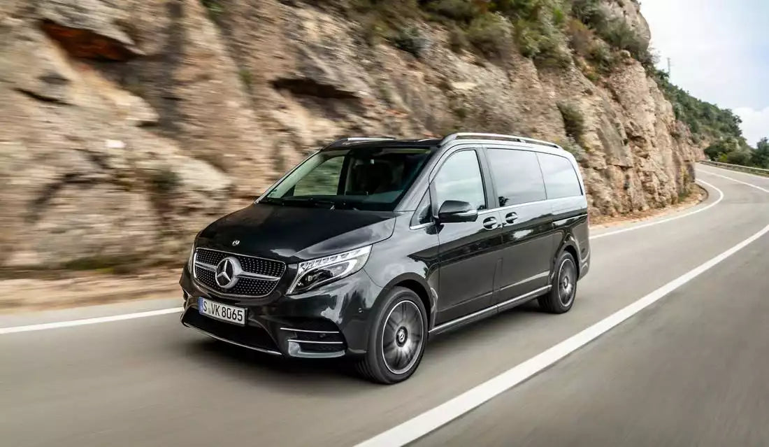 Black Mercedes-Benz van driving on a mountain road