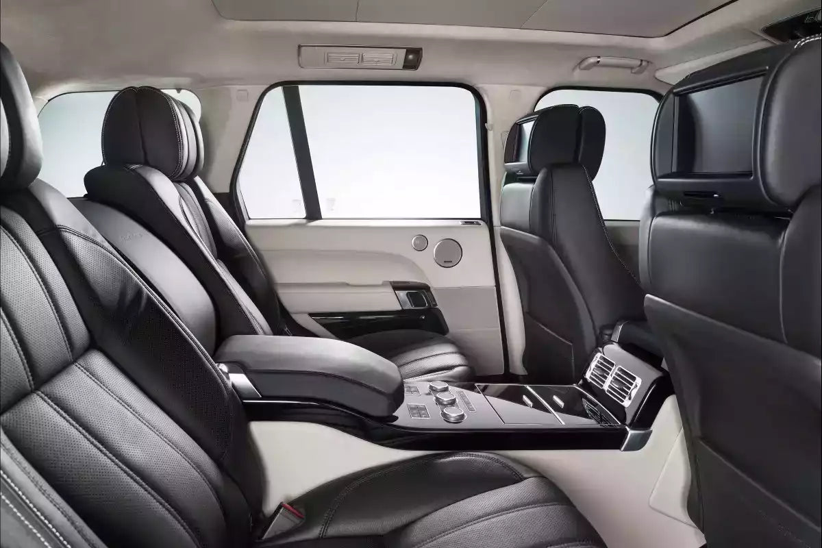 Luxury car interior with black leather seats and center console.
