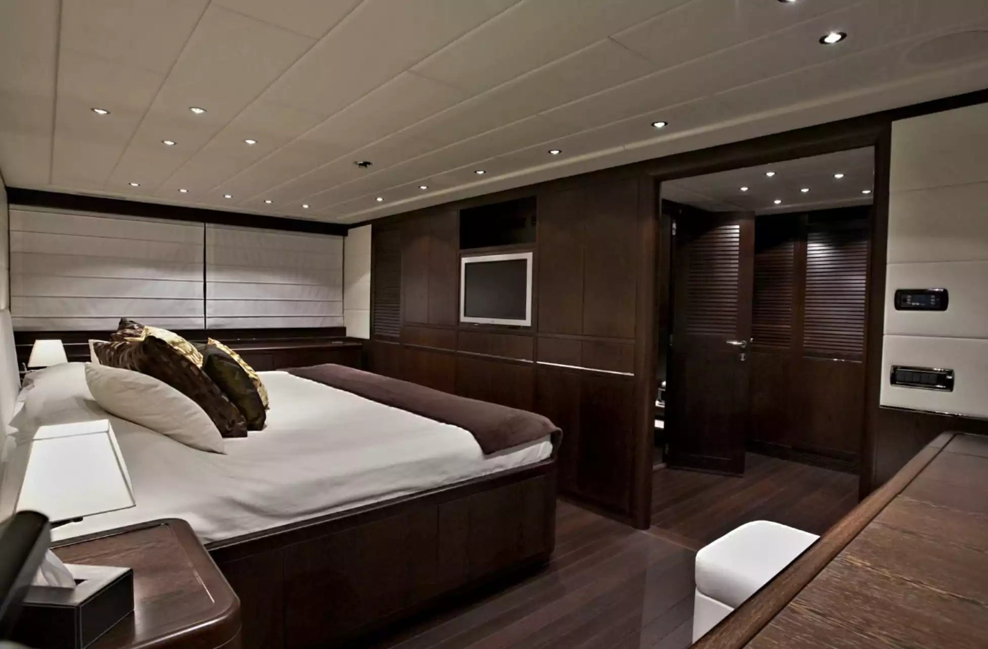 Modern bedroom with dark wood furniture and white bedding