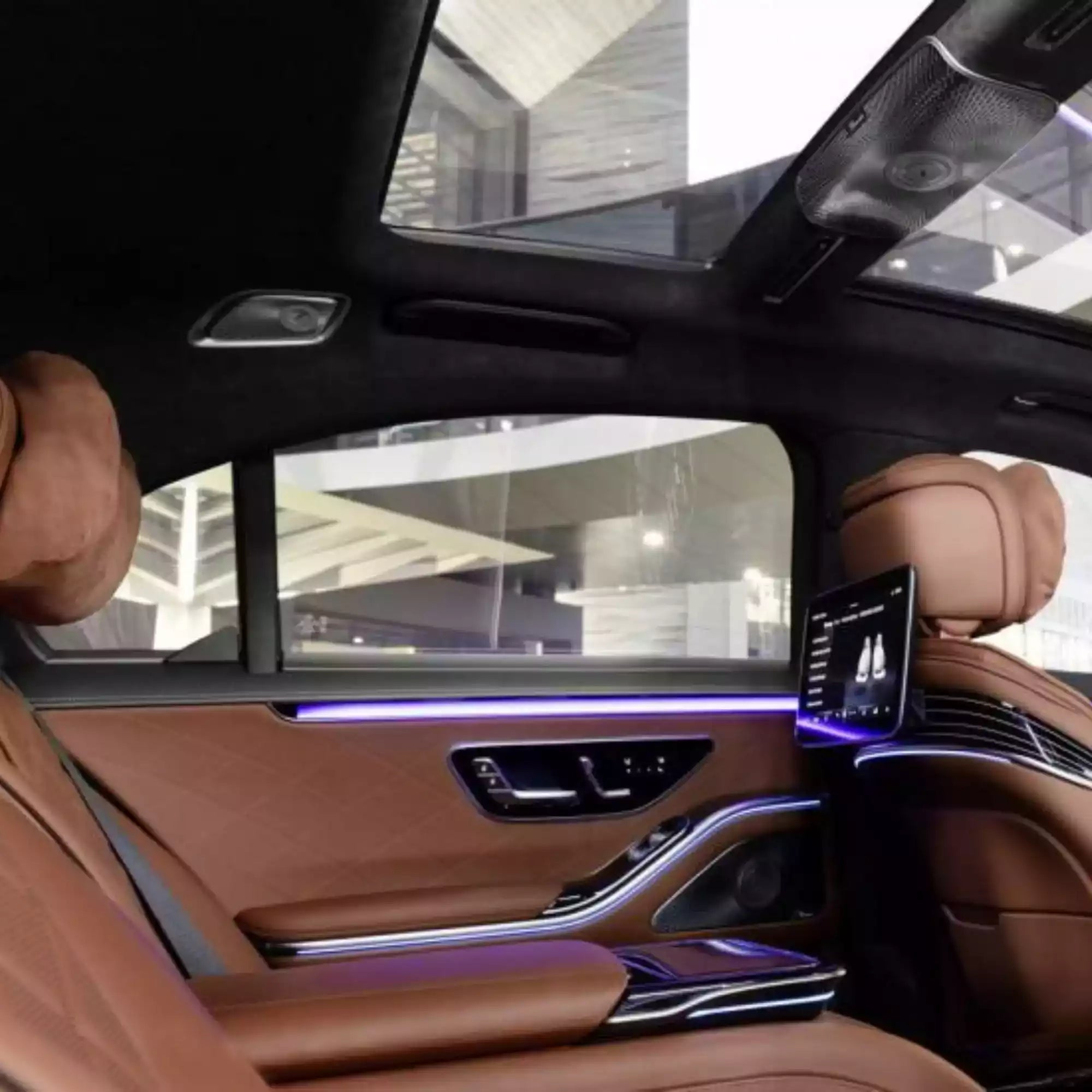Luxury car interior with brown leather seats and modern dashboard.