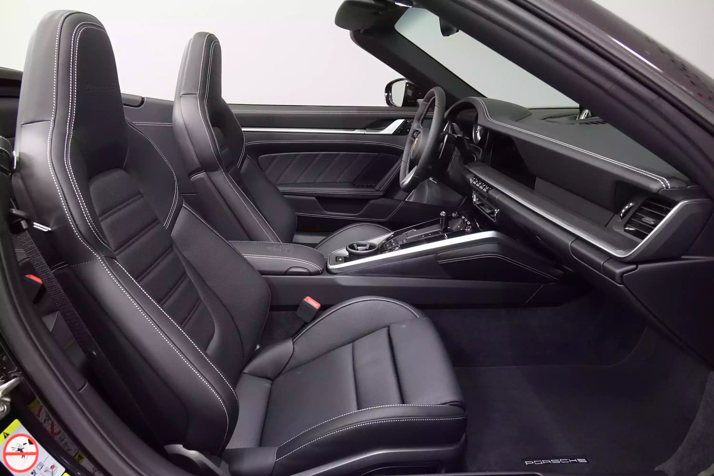 Car interior with black leather seats and dashboard.