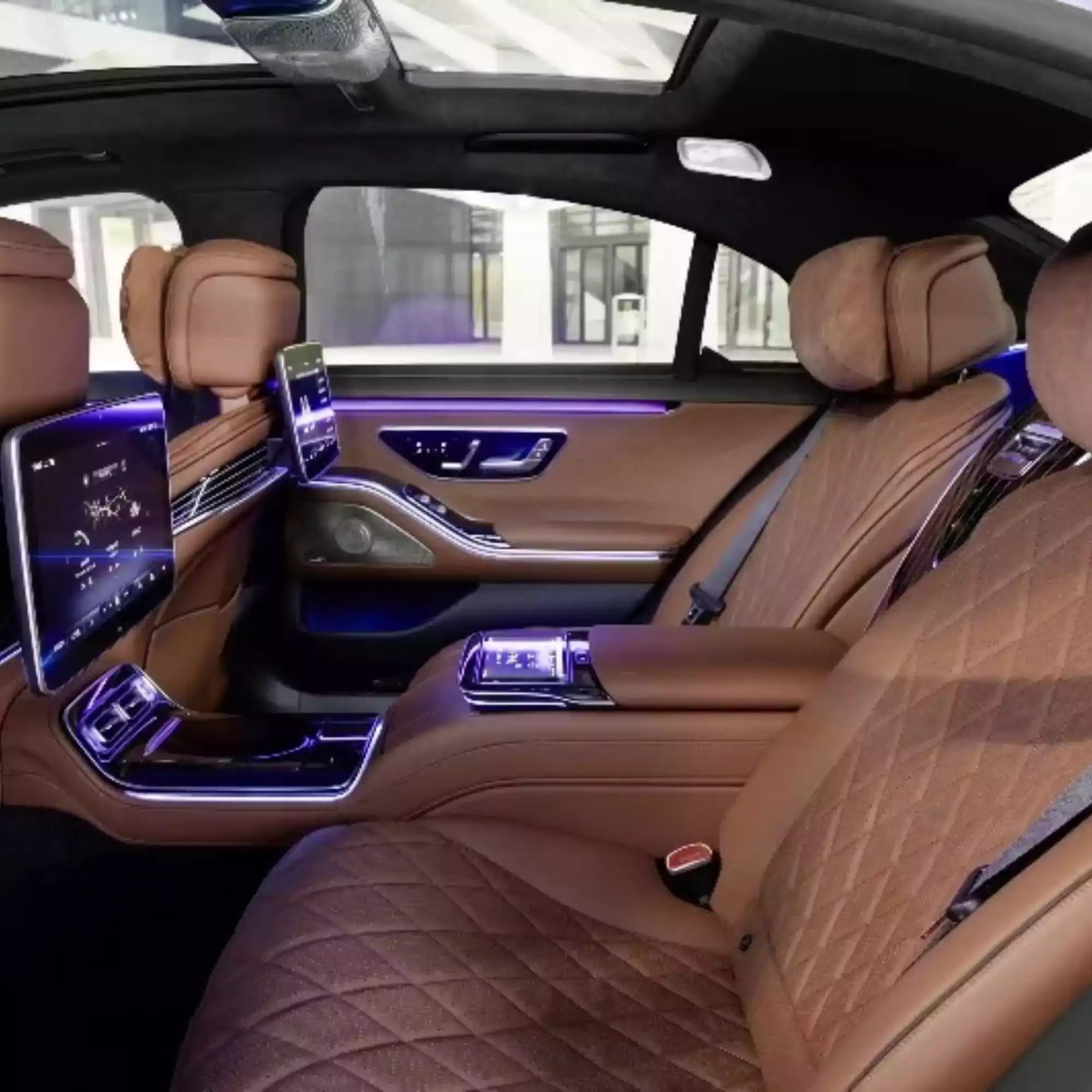 Luxury car interior with brown leather seats and modern dashboard.