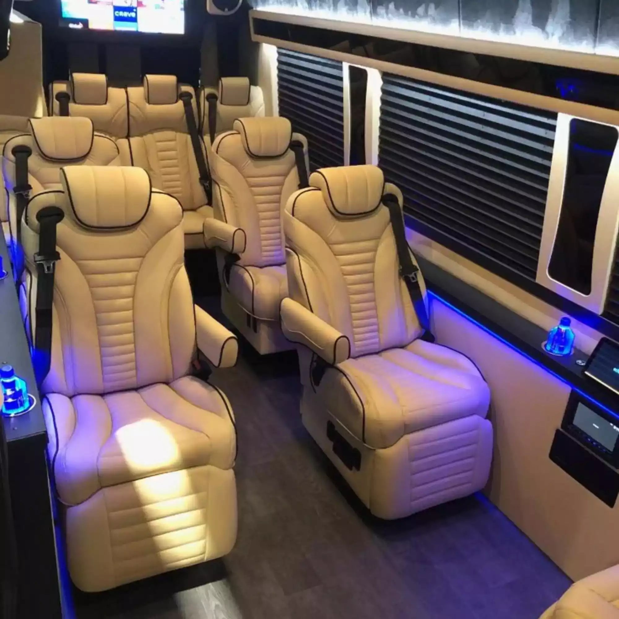 Luxury interior of a vehicle with beige leather seats and modern design elements.