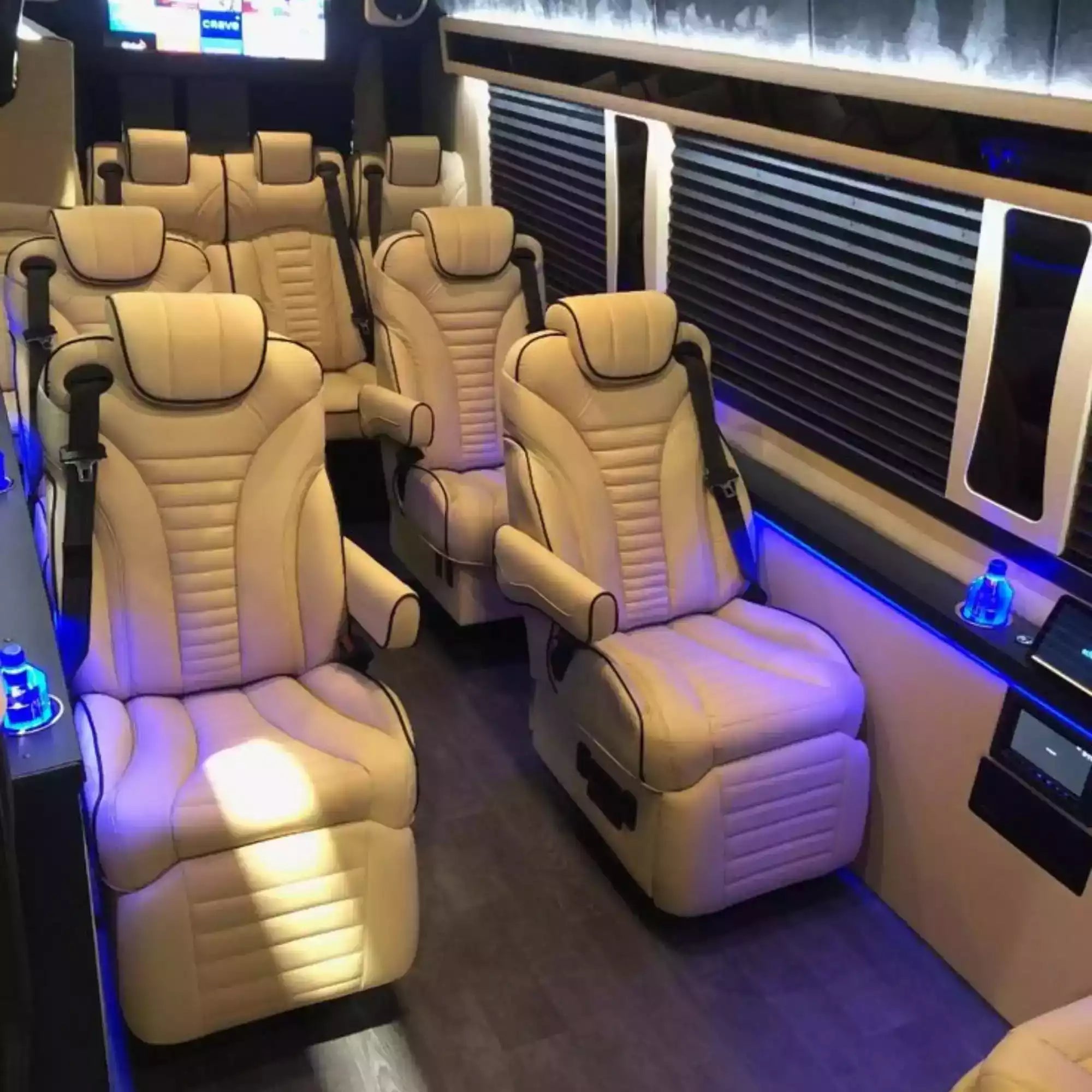 Luxury interior of a vehicle with beige leather seats and modern design elements.