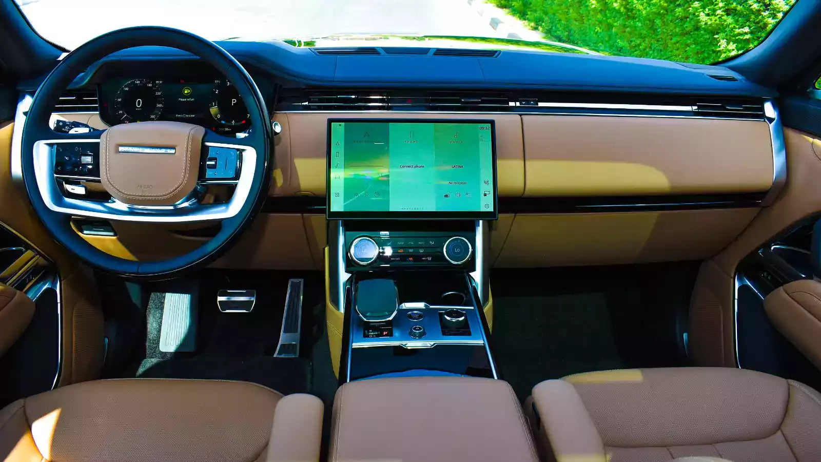 Luxury car interior with a focus on the dashboard and touchscreen display.