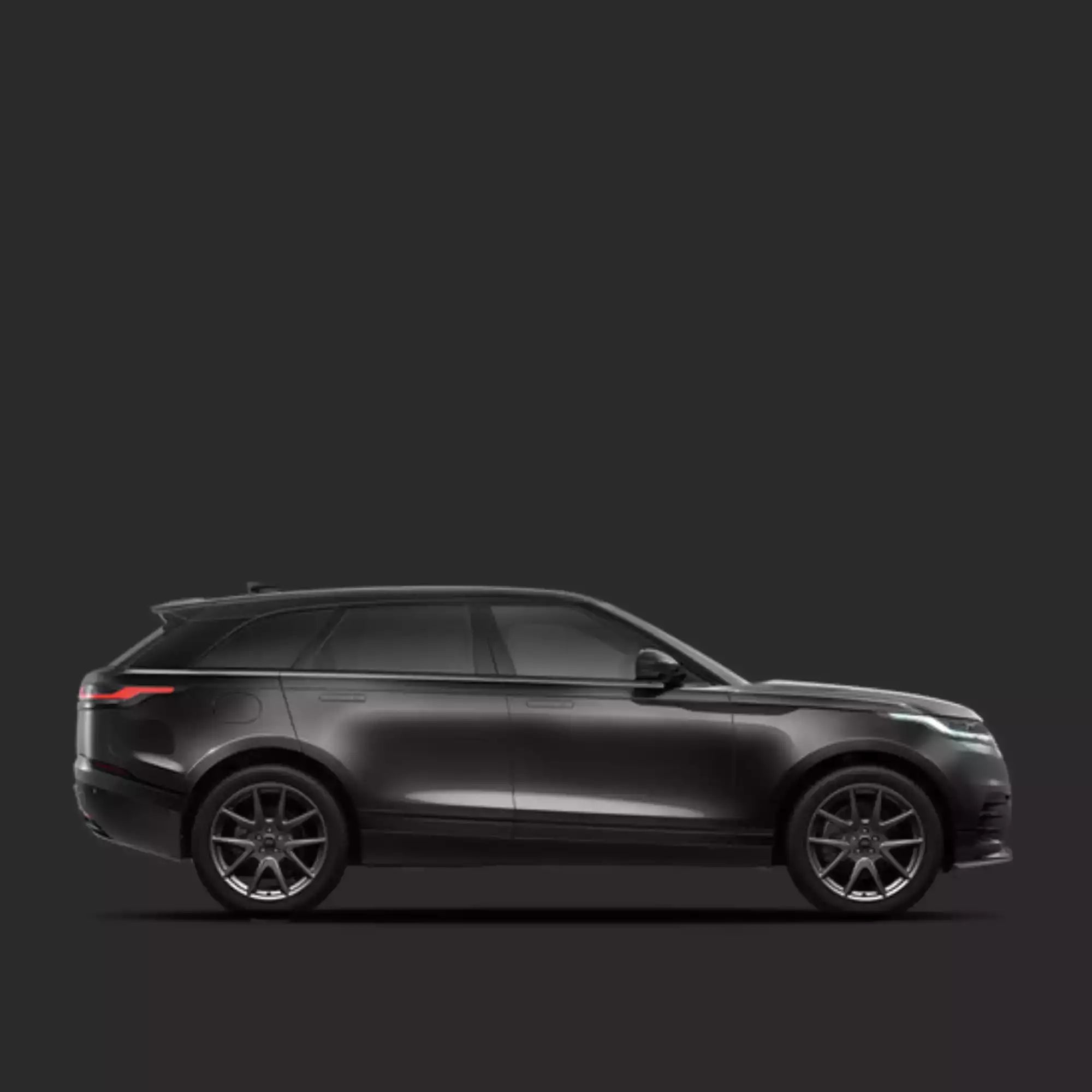 Side view of a black SUV on a dark background