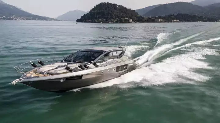 Speedboat on a body of water with mountains in the background