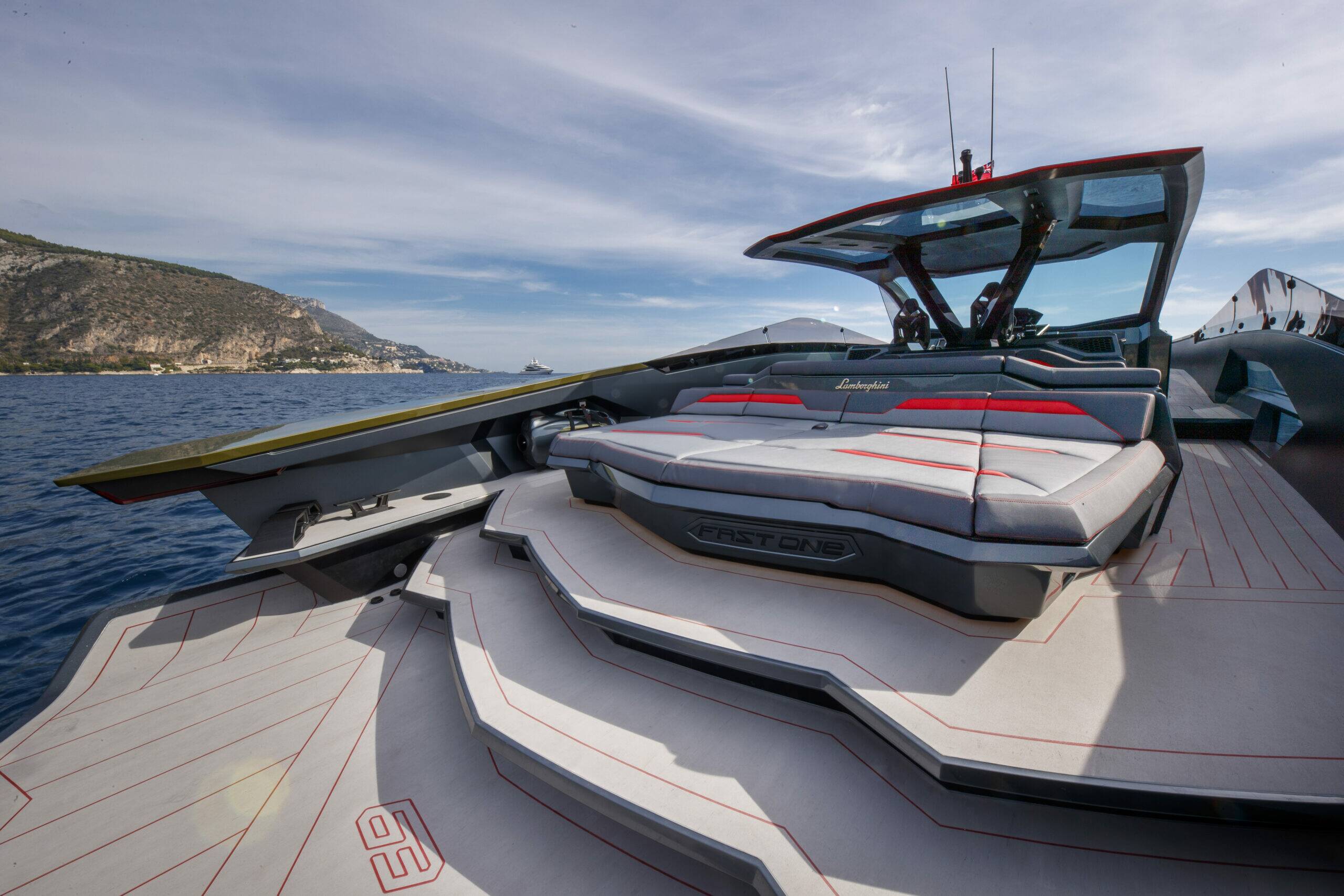 Carbon fiber yacht gliding past Monte Carlo skyline