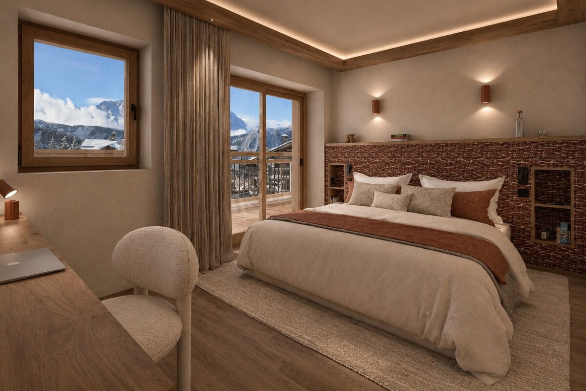 A luxury ski chalet bedroom featuring a large bed with cream bedding, a textured brown headboard, a built-in desk, and large windows showcasing a mountain view.