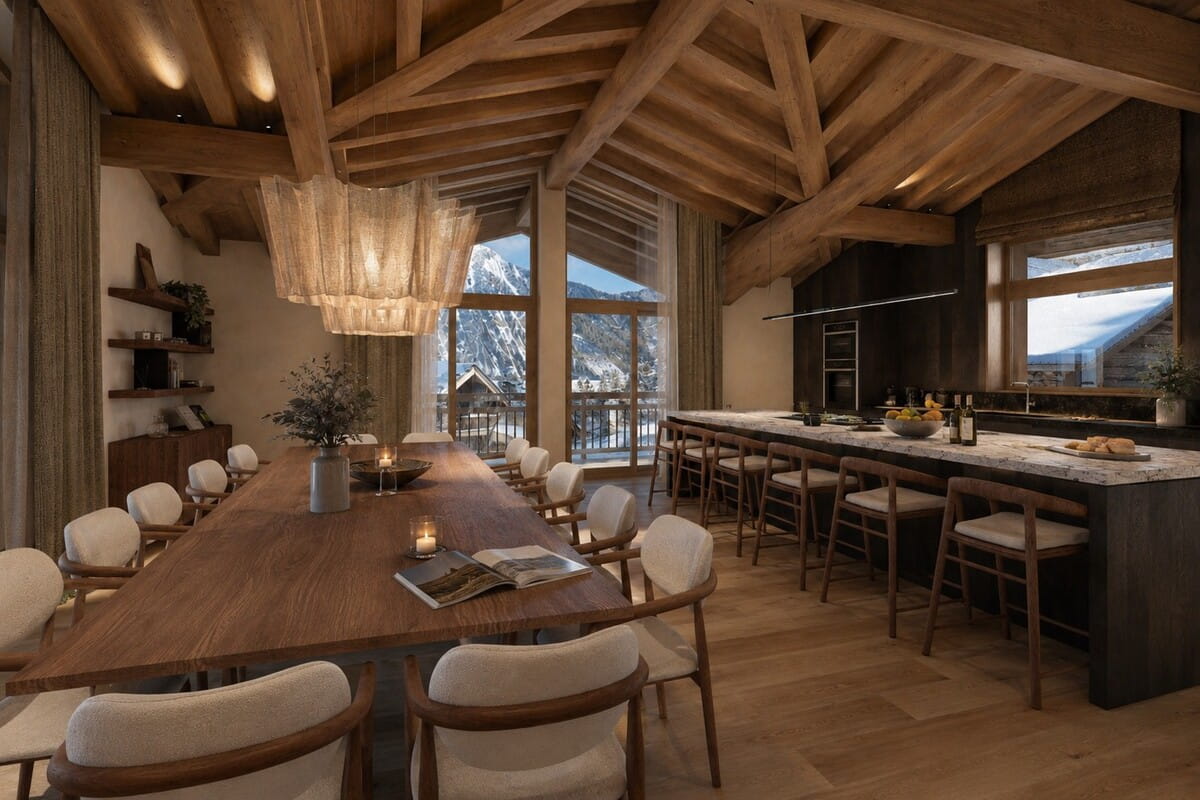 A luxury chalet dining room and kitchen featuring a large wooden dining table with cream upholstered chairs, a long island bar with matching stools, and a high wooden ceiling with exposed beams. Large windows offer a view of snowy mountains.