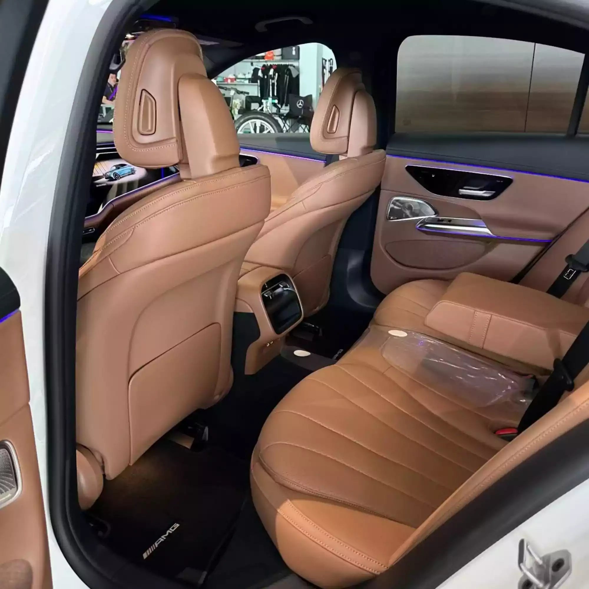 Luxury car interior with tan leather seats and modern design.