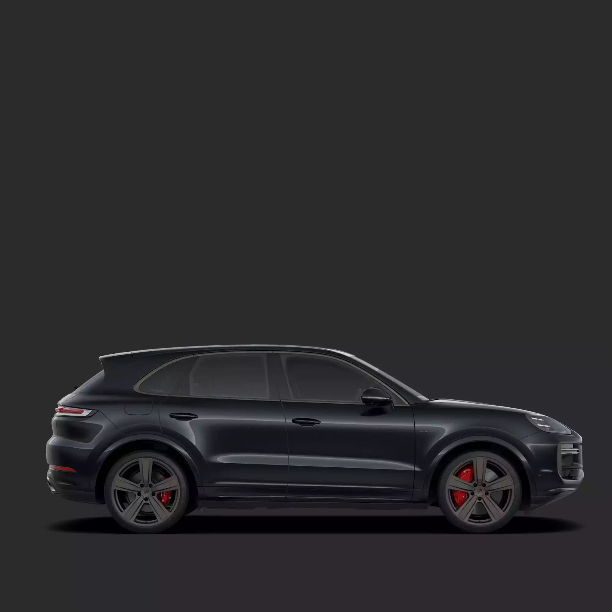 Side view of a black SUV on a dark background