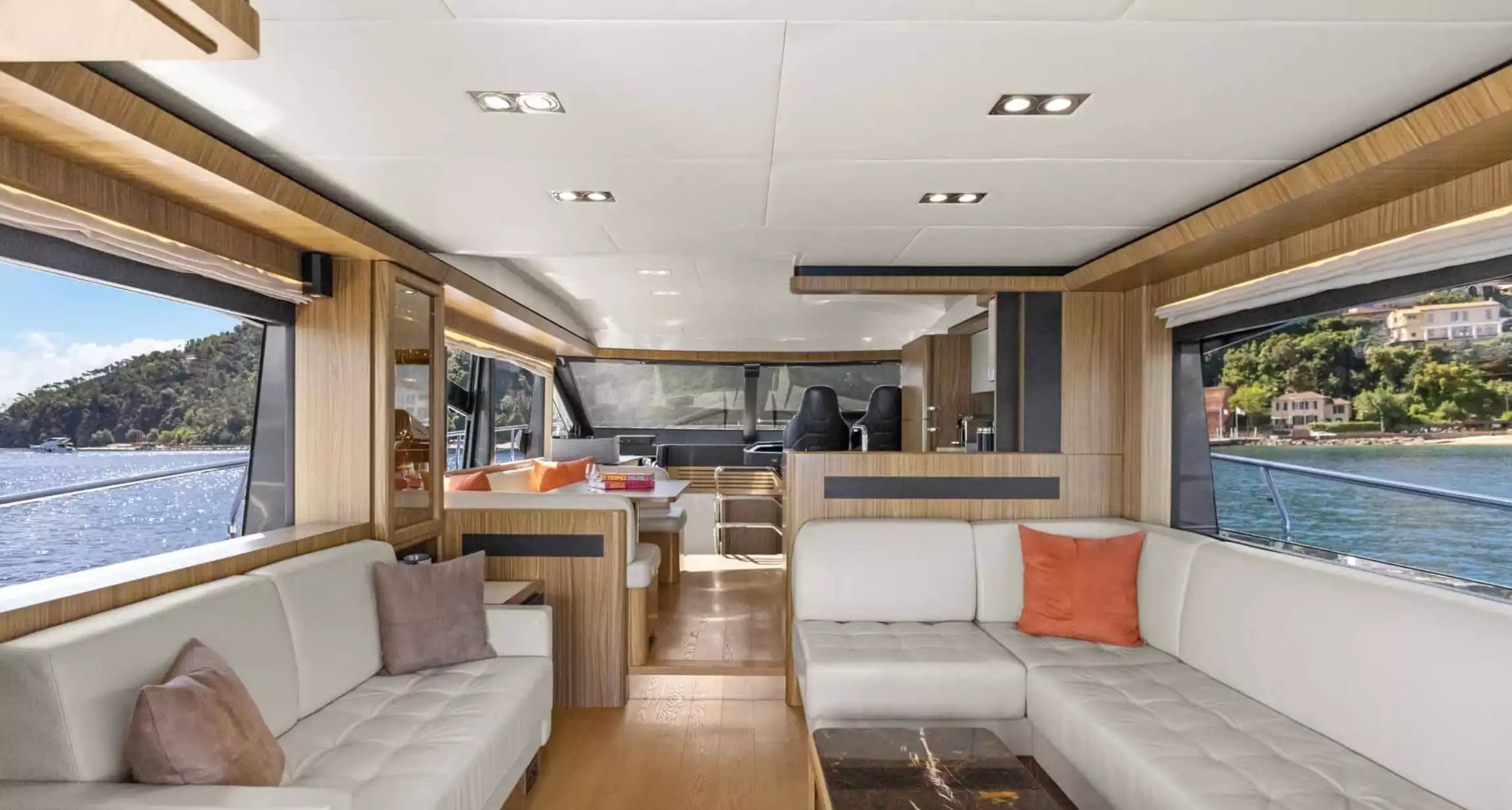 Interior of a luxurious boat with modern decor and large windows.