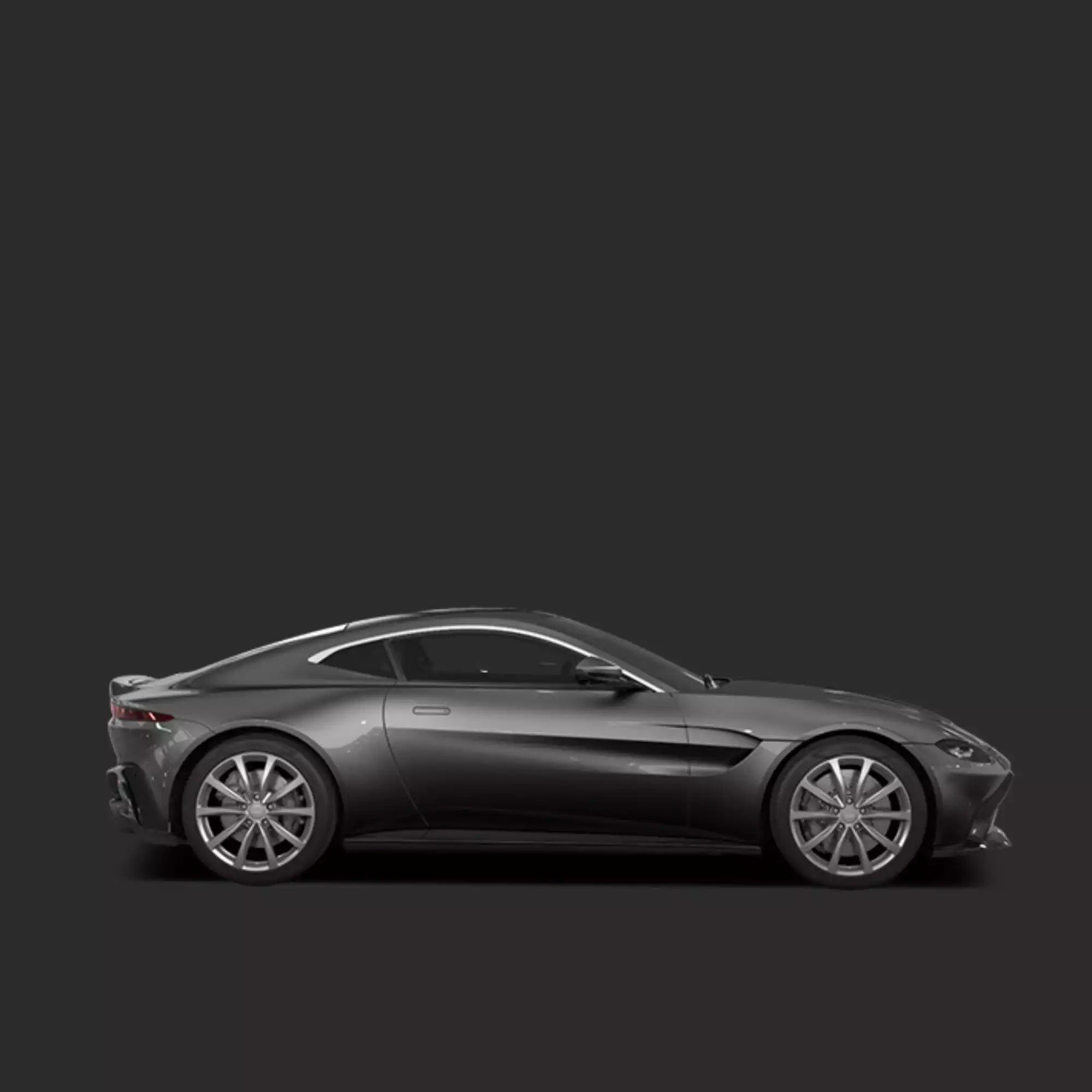 A dark gray Aston Martin Vantage sports car shown in a side profile view against a solid dark gray background.