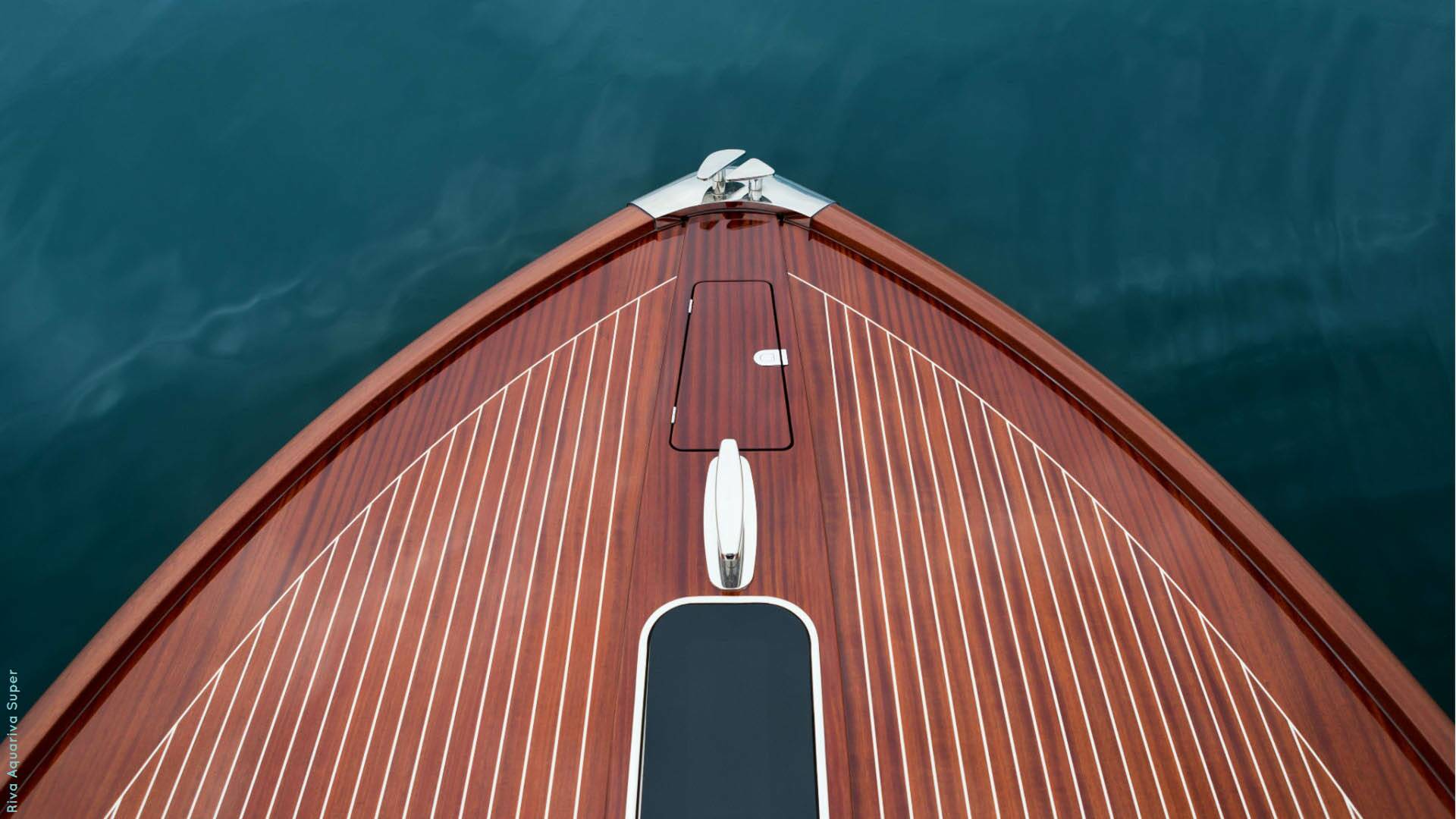 Close-up of a wooden boat's bow with water in the background