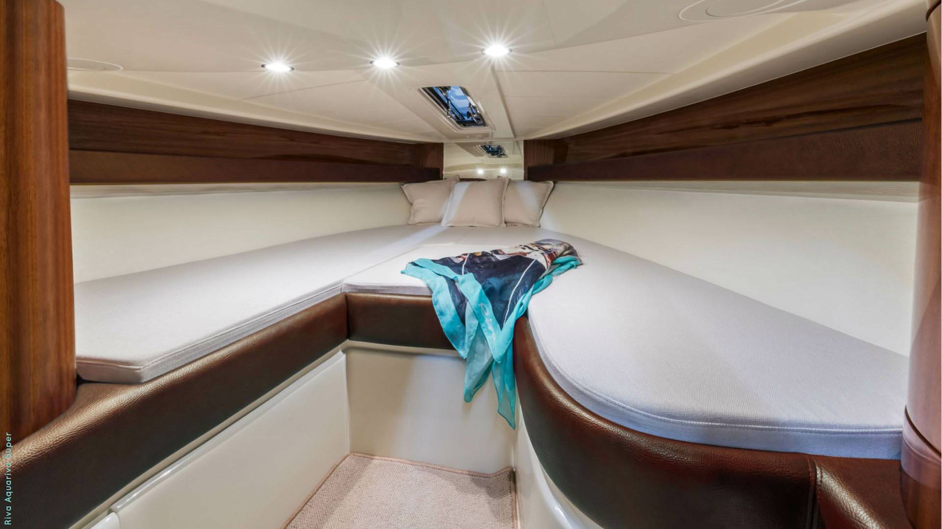 Interior of a boat cabin with a couch and blanket