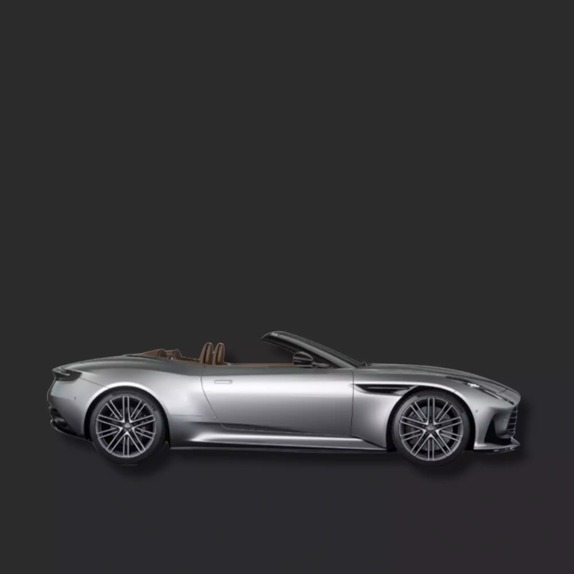 A silver convertible sports car shown in a side profile view against a dark gray background.