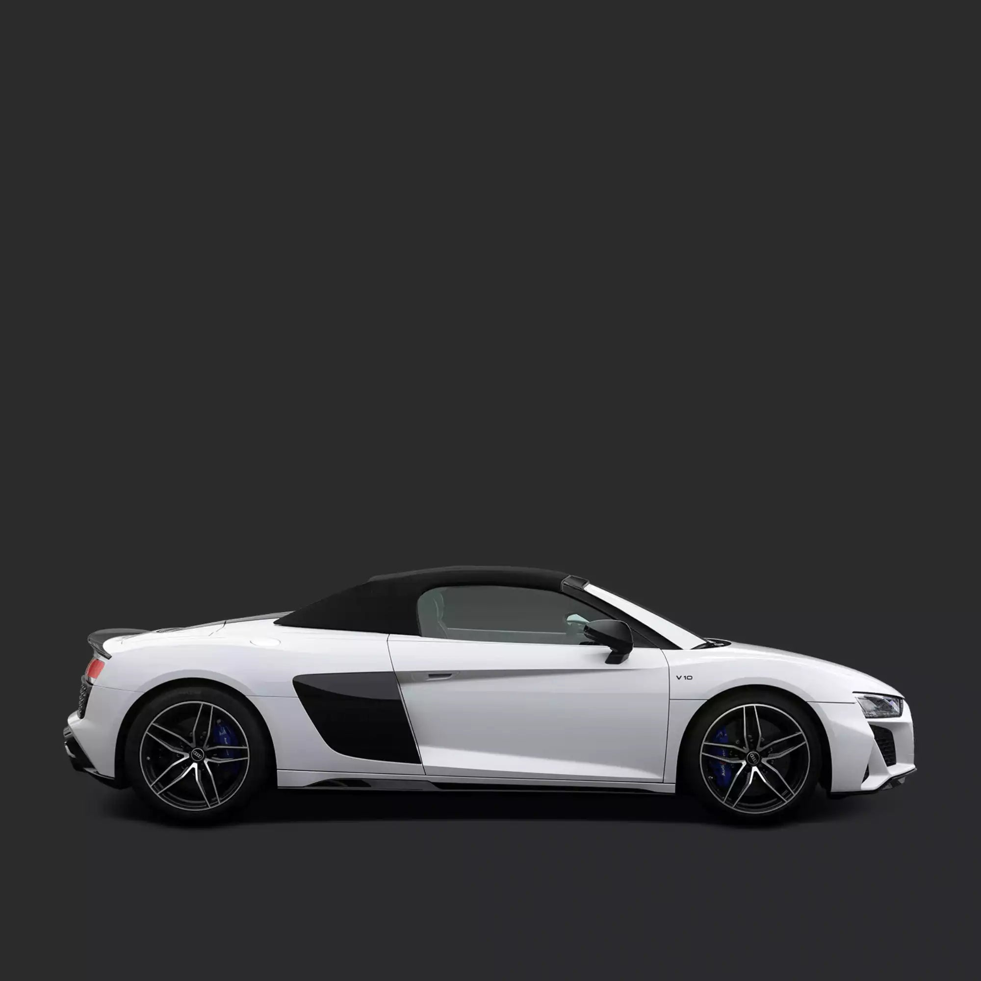 A white convertible sports car shown in a clean side profile against a dark gray studio background.