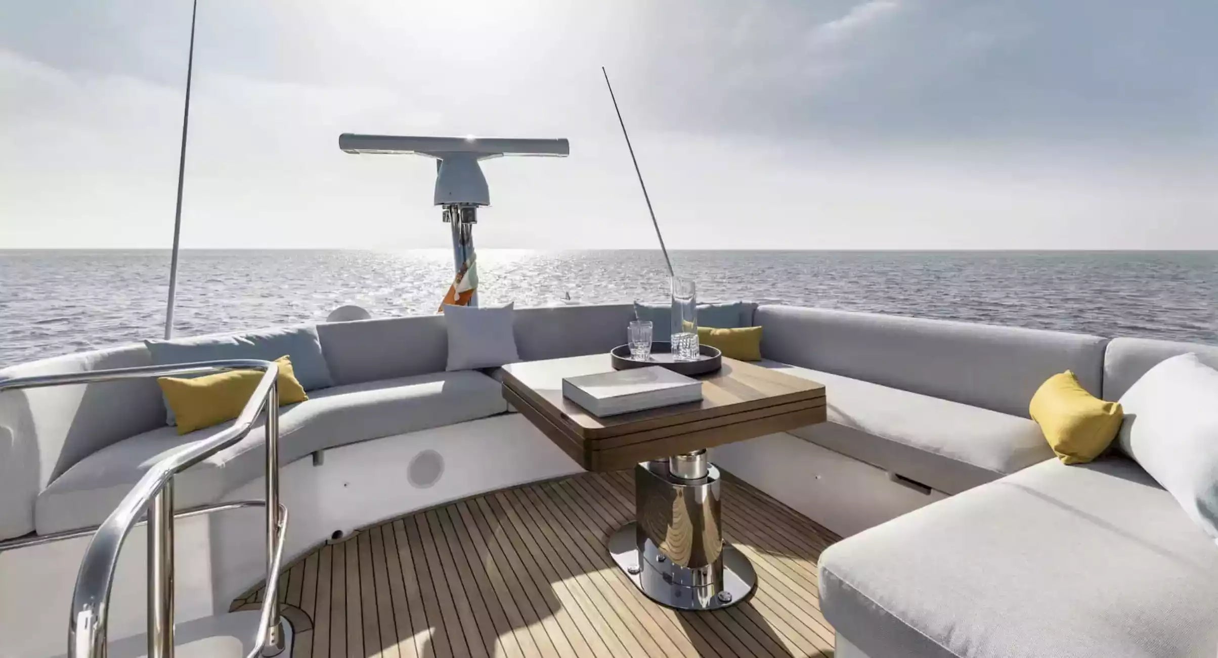 Yacht deck with seating area and table on a clear day