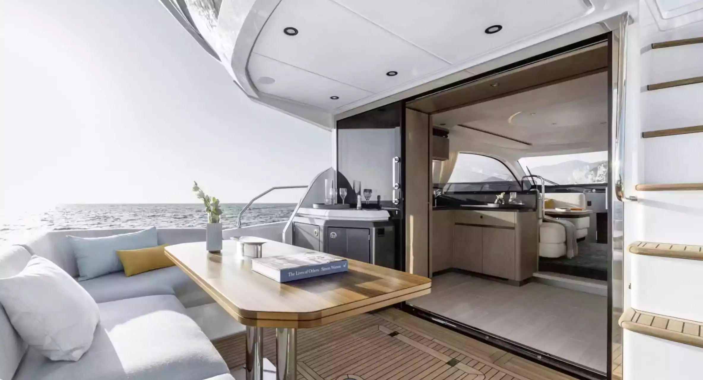 Interior of a luxurious yacht with modern decor and large windows.