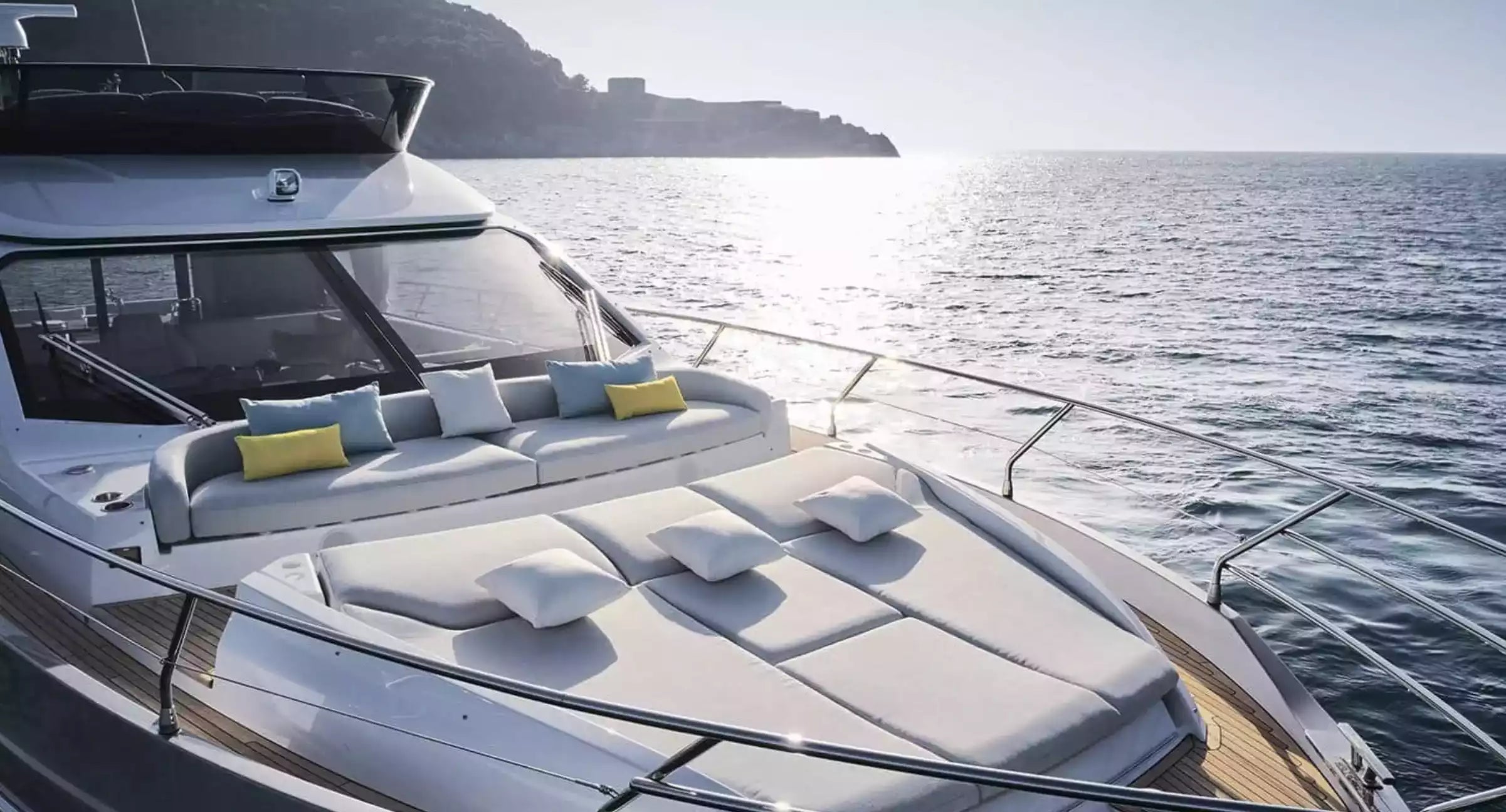 Luxury yacht with outdoor seating area on a sunny day