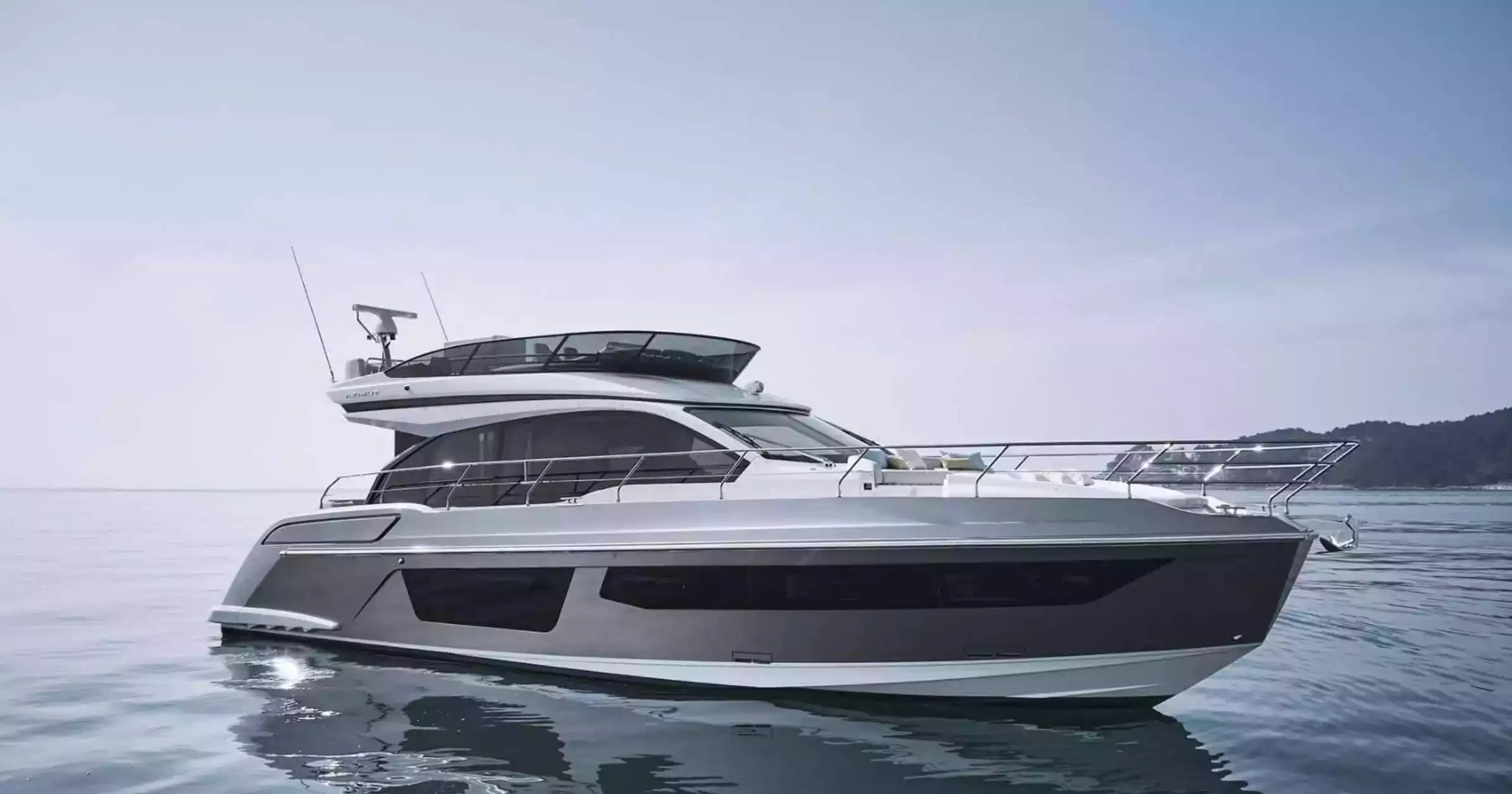 Yacht on a calm body of water with a clear sky