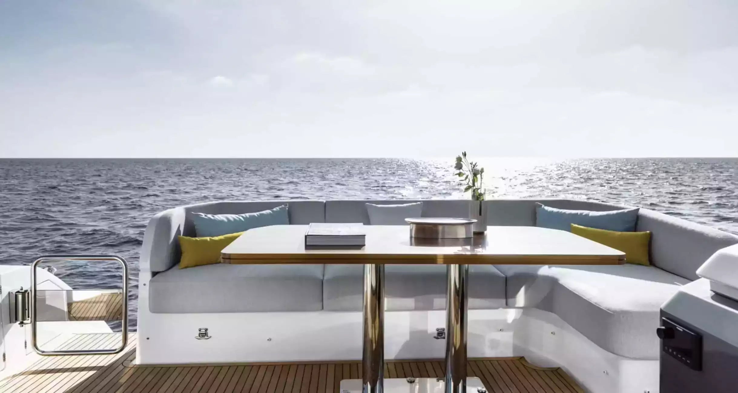 Yacht deck with seating area and table on a clear day
