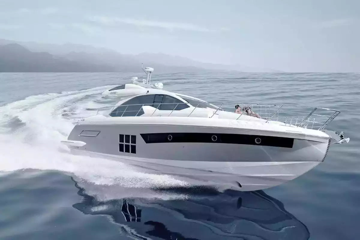 White yacht speeding across a body of water