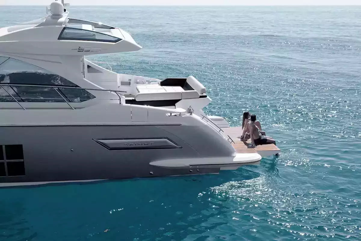 Luxury yacht with people on a sun deck against a clear blue sky.