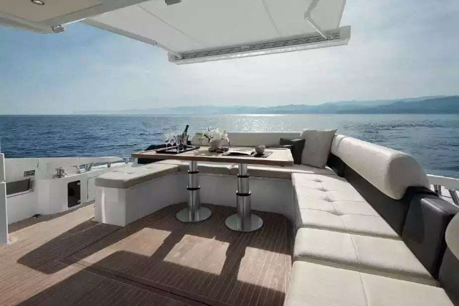 Yacht deck with seating area and kitchenette overlooking the ocean