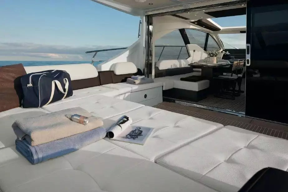 Interior of a luxurious yacht with white couches and ocean view