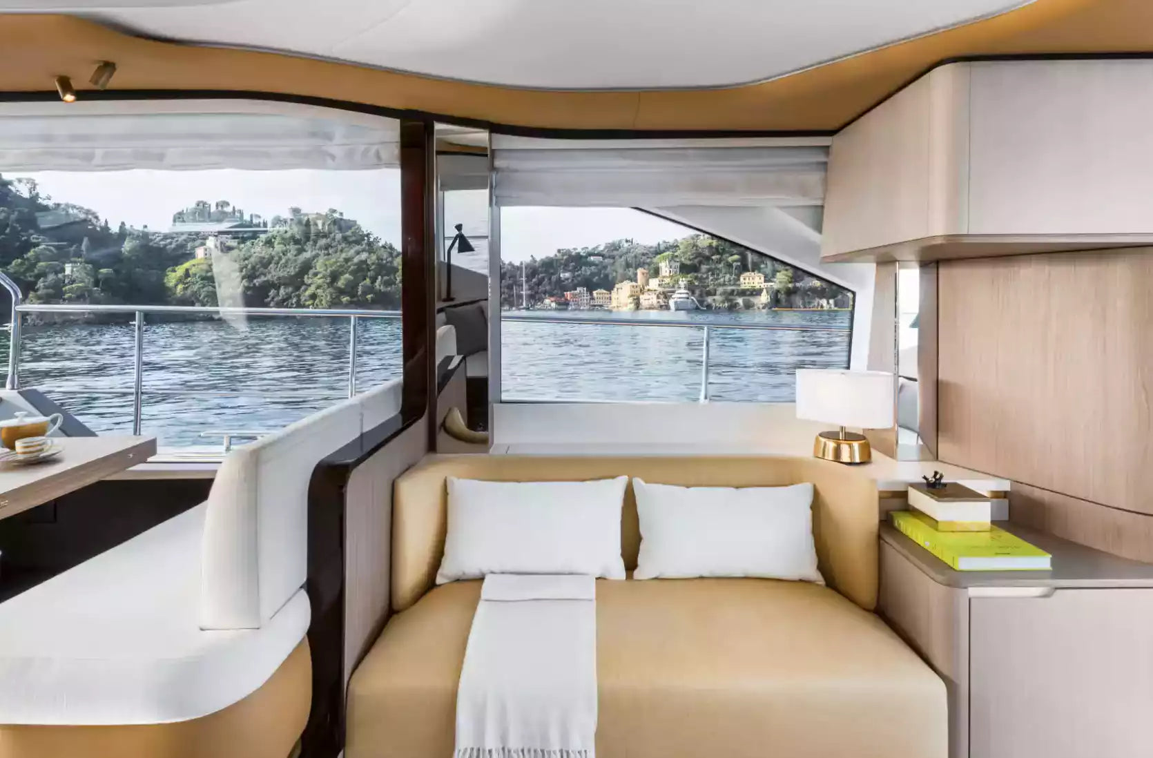 Interior of a luxurious yacht with a view of water and trees.