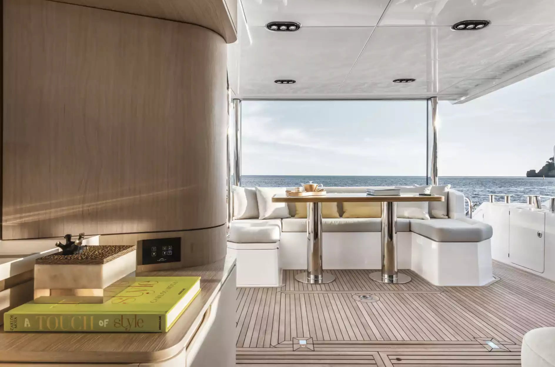 Interior of a luxurious yacht with a dining table and seating area.