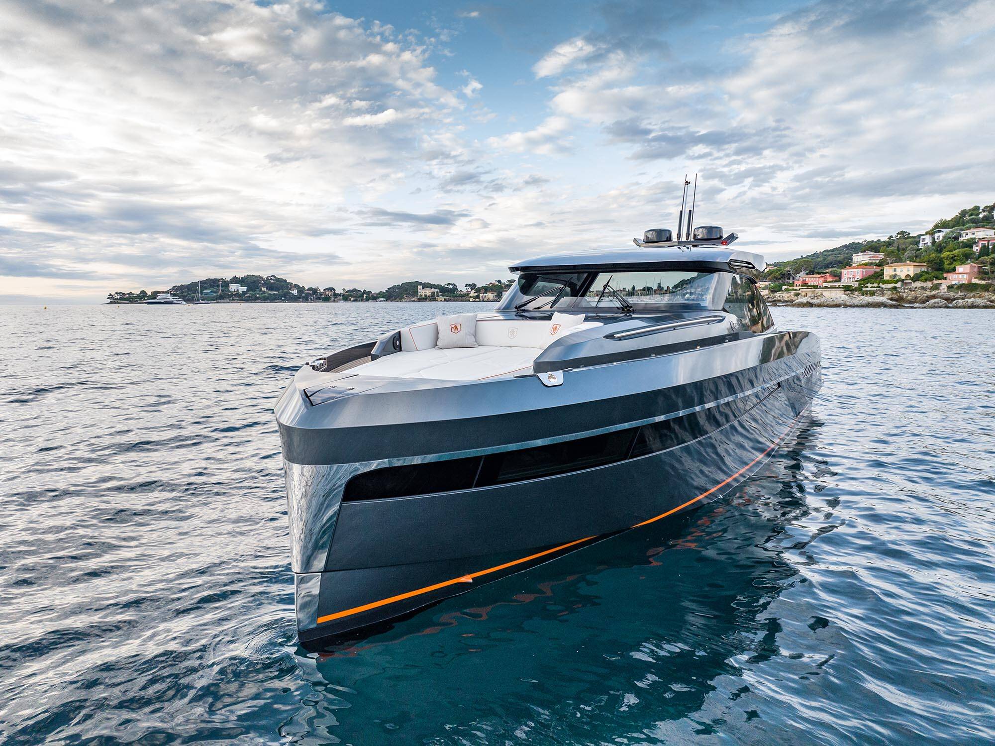 Luxury yacht on the water with a coastal landscape in the background