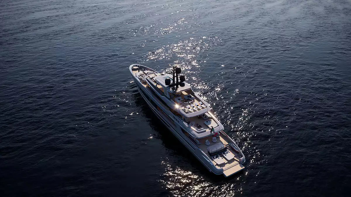 An aerial view of a luxury yacht sailing on dark blue water, leaving a white wake behind it.