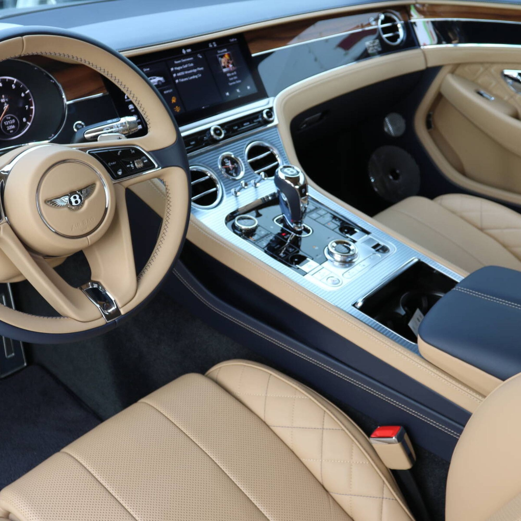Luxury car interior with beige steering wheel and dashboard