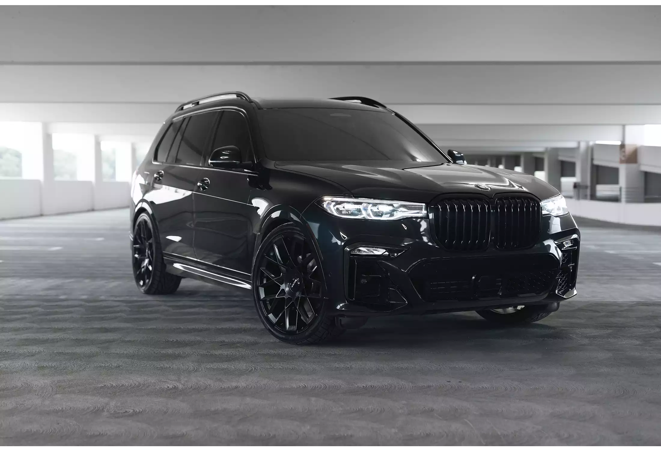 Black SUV parked in a modern building interior