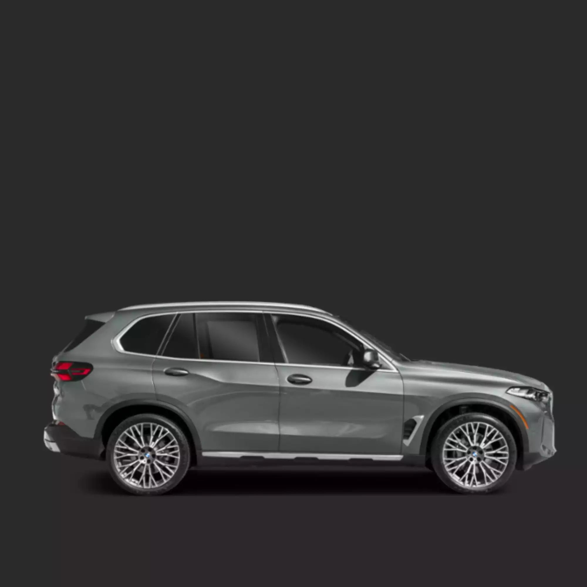 Side view of a silver SUV on a dark background