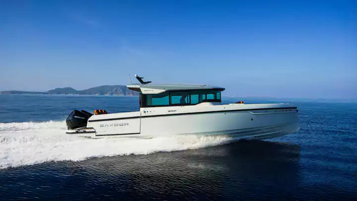White boat with blue interior on a body of water under a clear blue sky