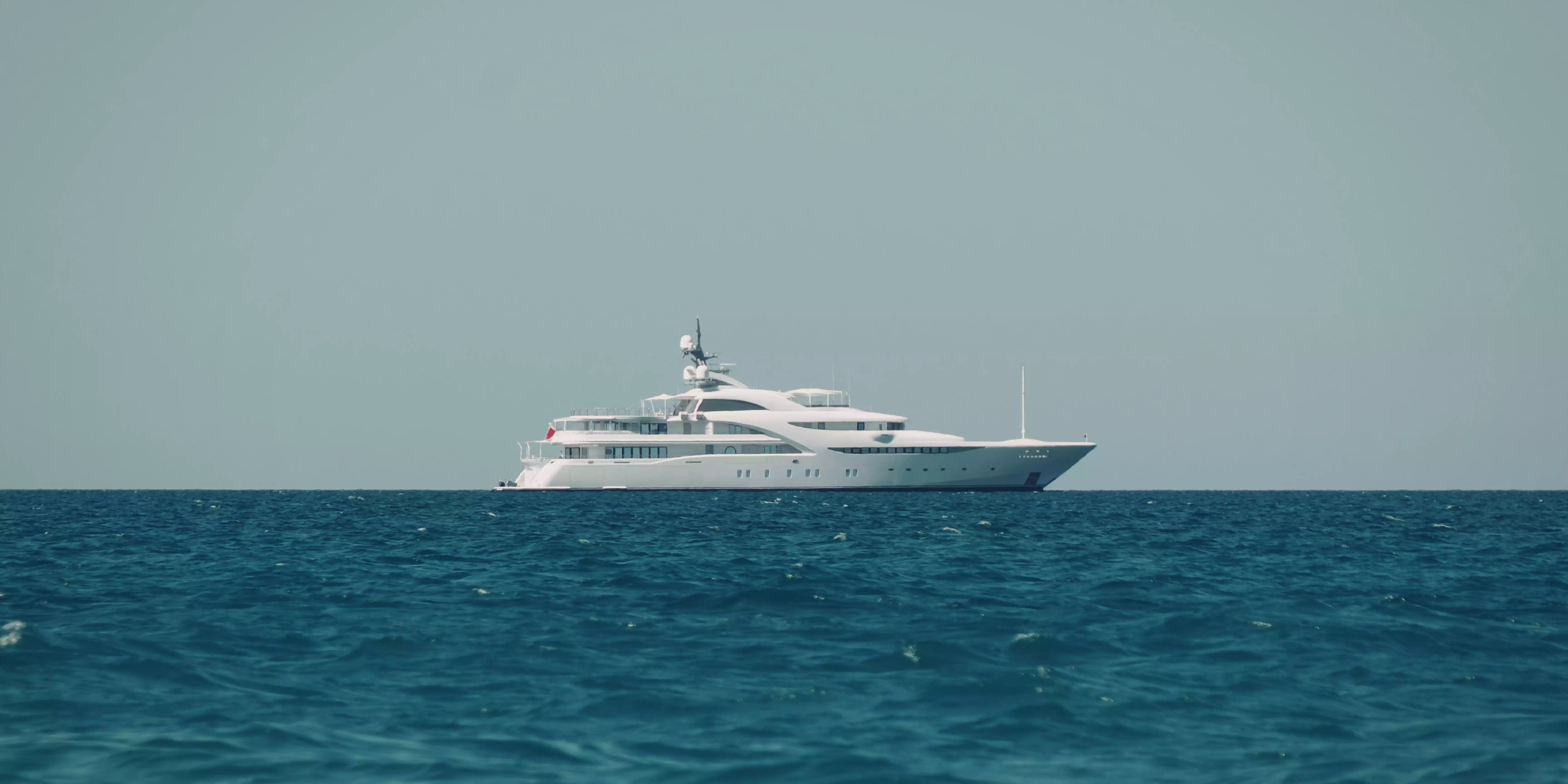 White yacht on the ocean with a clear sky