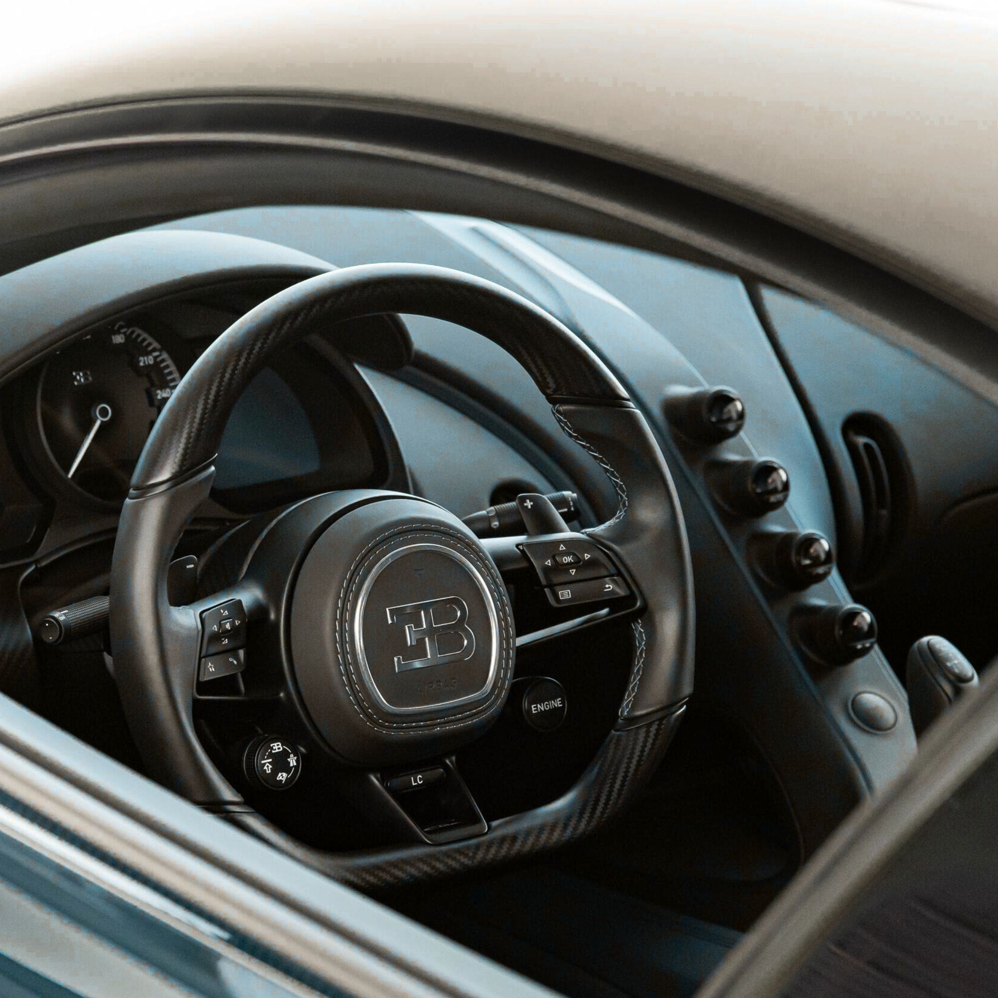 Steering wheel with Bugatti logo in a car interior