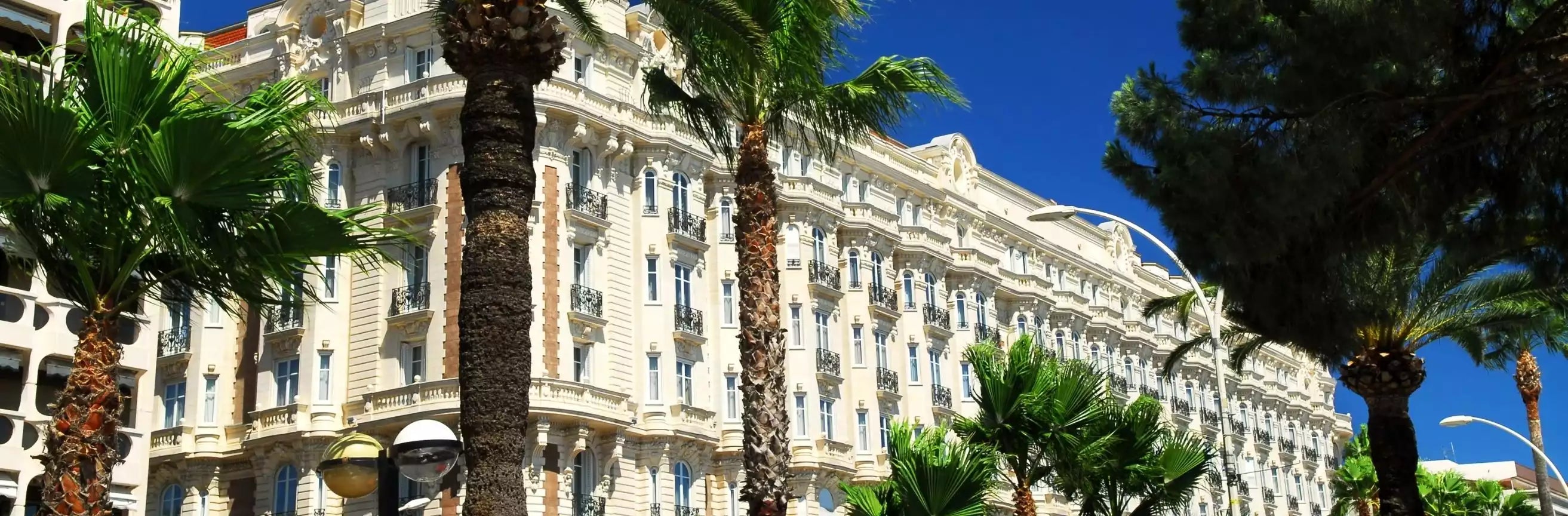 Luxury hotel with palm trees against a blue sky