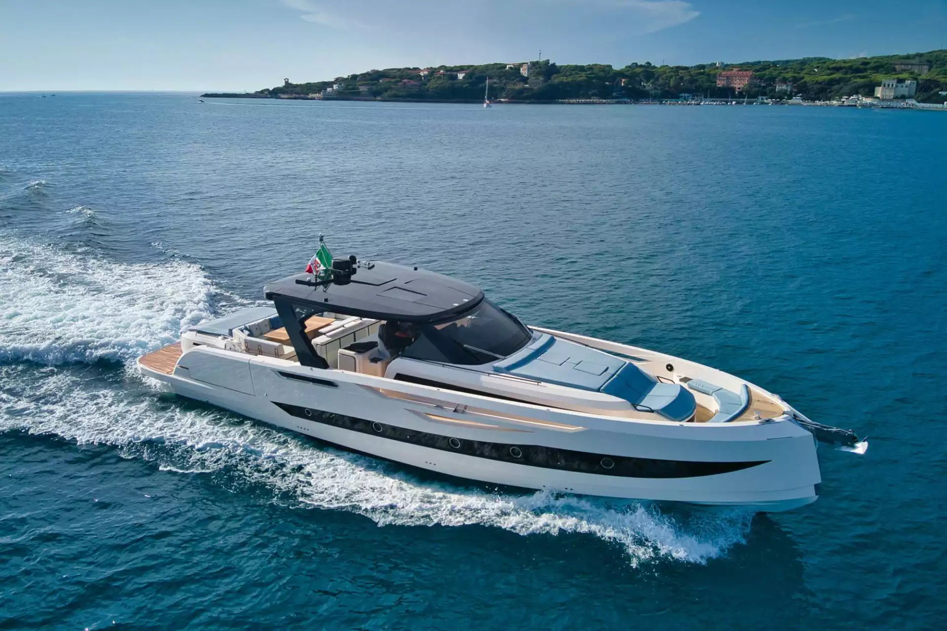 Luxury yacht on the water with a coastal town in the background