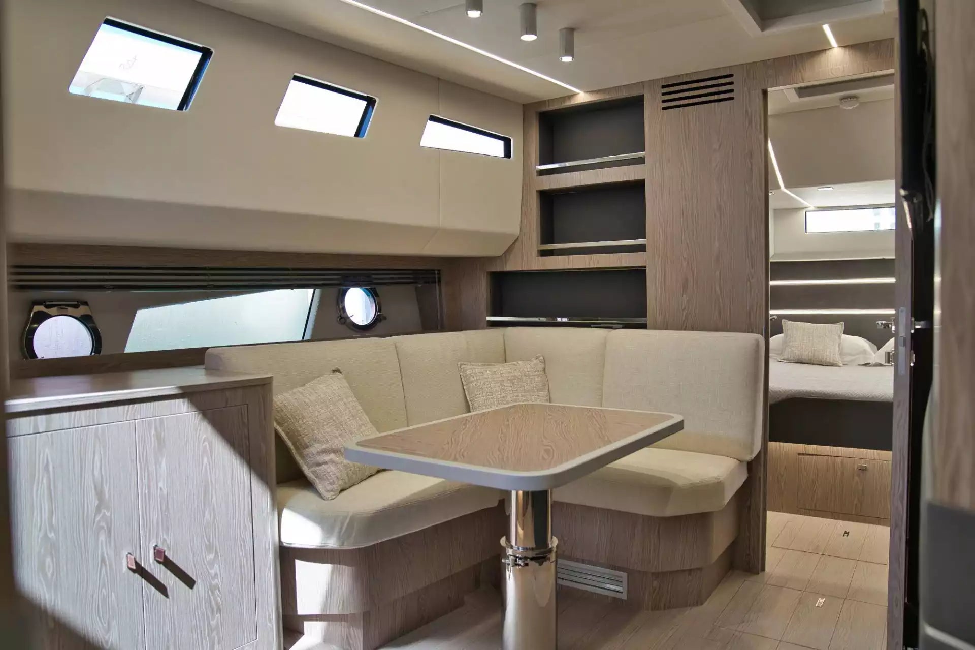 Interior of a modern vehicle with a seating area and table.