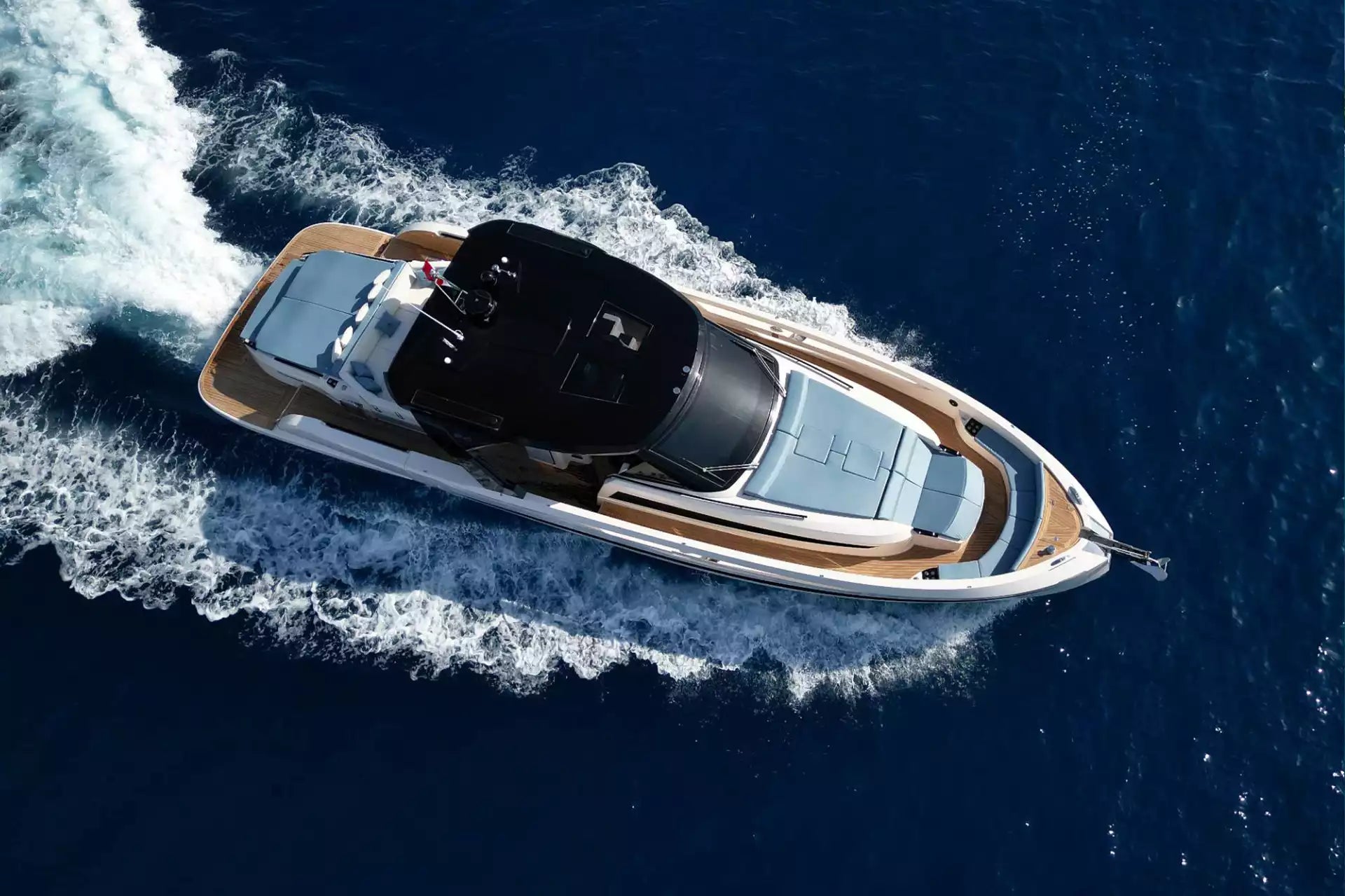 Speedboat cutting through water on a clear day