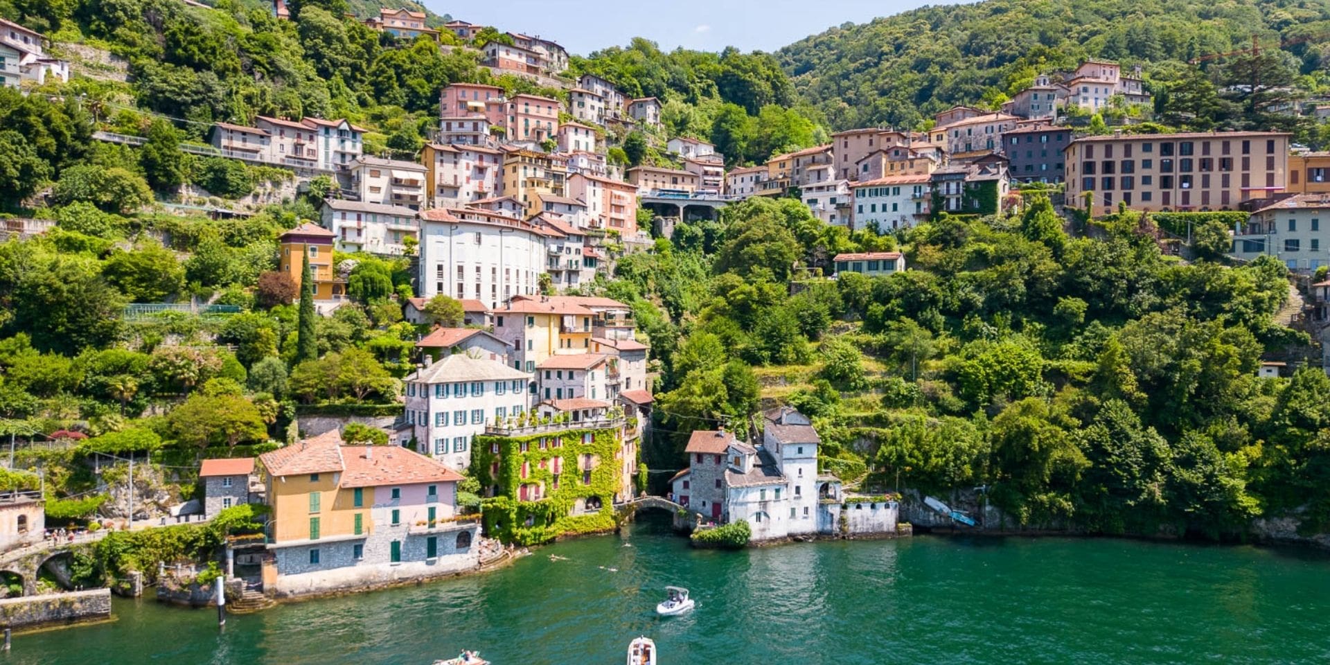 Village by a lake with houses and greenery