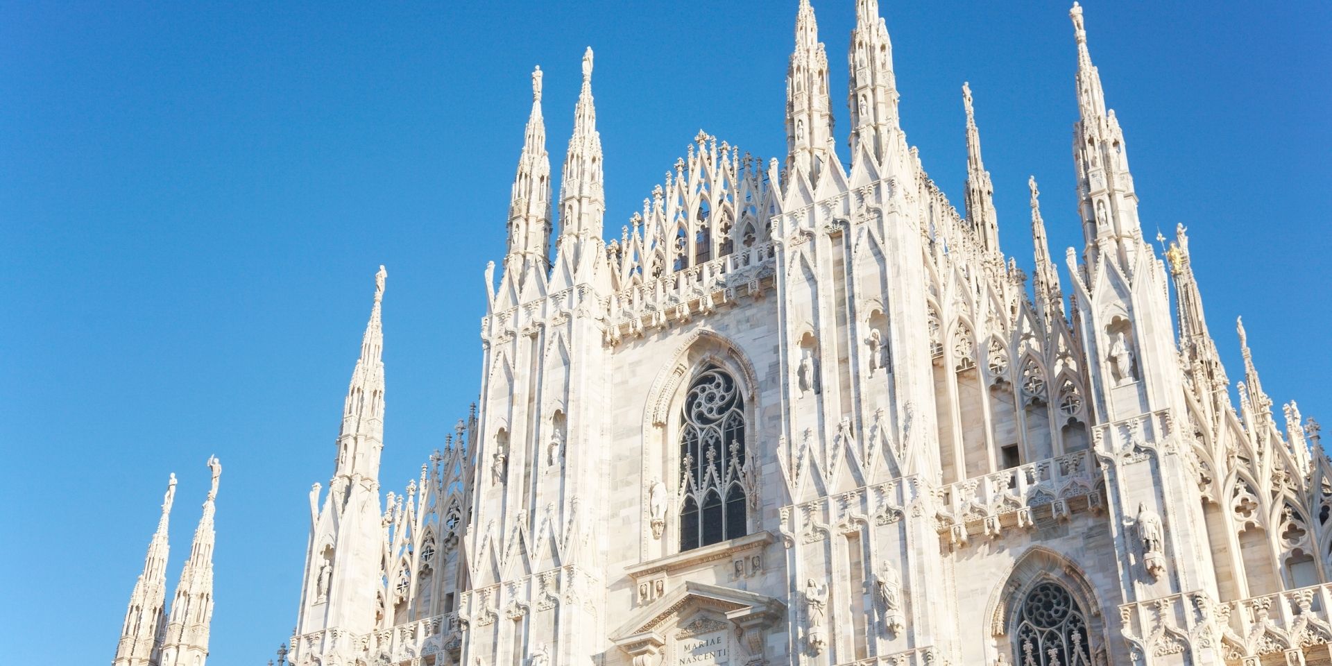 Gothic cathedral with spires against a clear blue sky
